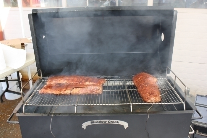 https://mdbbqservices.com/wp-content/uploads/2022/03/Meadow_Creek_PR36_Pig_Roaster_Smoker_Loaded_with_Meat.jpg